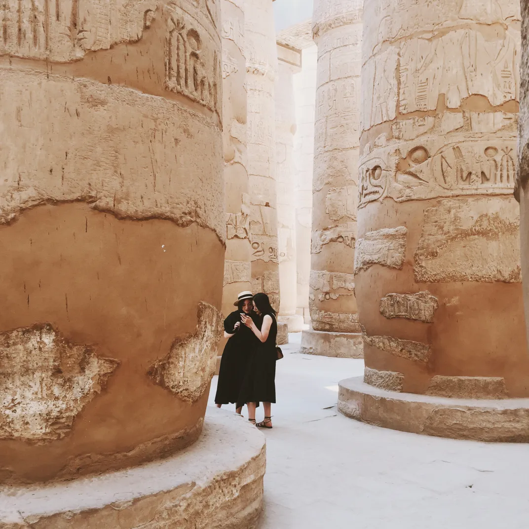 5 - Two tourists check to make sure they are successfully chronicling their trip to the Karnak Temple.