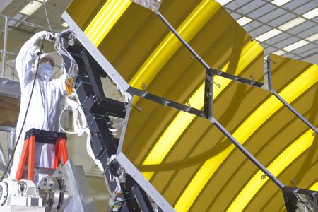 Part of the primary mirror for the James Webb Space Telescope. Imagine this, but... more.