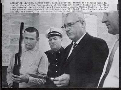 Officers display the weapons used in the November 15, 1959, killings of the Clutter family.