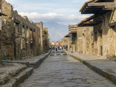 Tourist Carves His Family's Initials Onto a Wall in Pompeii image