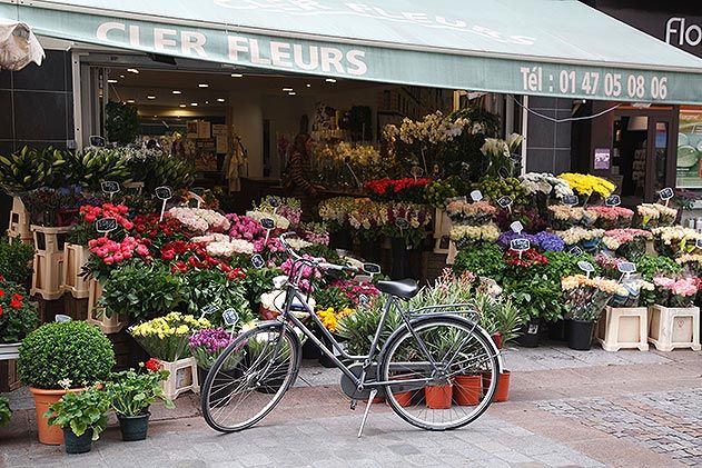 Bicycle outside flower stall Rue Cler Paris