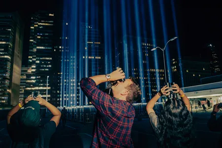 Dustin Partridge of the New York City Bird Alliance looks for migrating birds during the 2024 Tribute in Light in New York City.