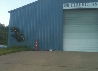 A Tyrannosaurus busting out of a fiberglass shop near Hindsville, Arkansas
