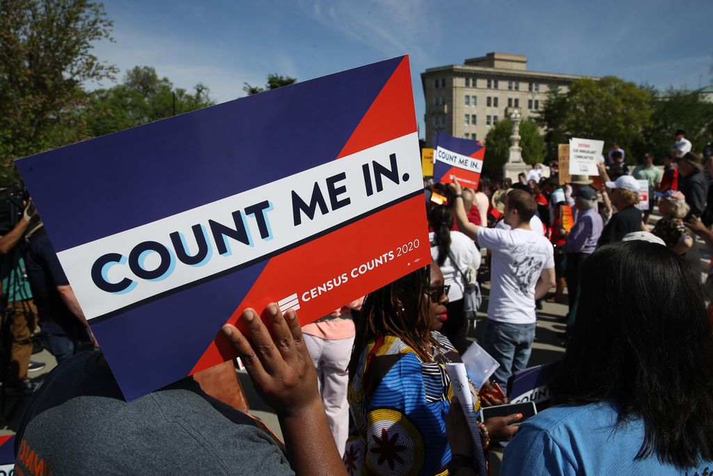 A protestor holds a sign that says "Count Me In"