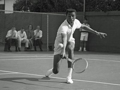 Arthur Ashe&nbsp;playing tennis against Dennis Ralston in 1964