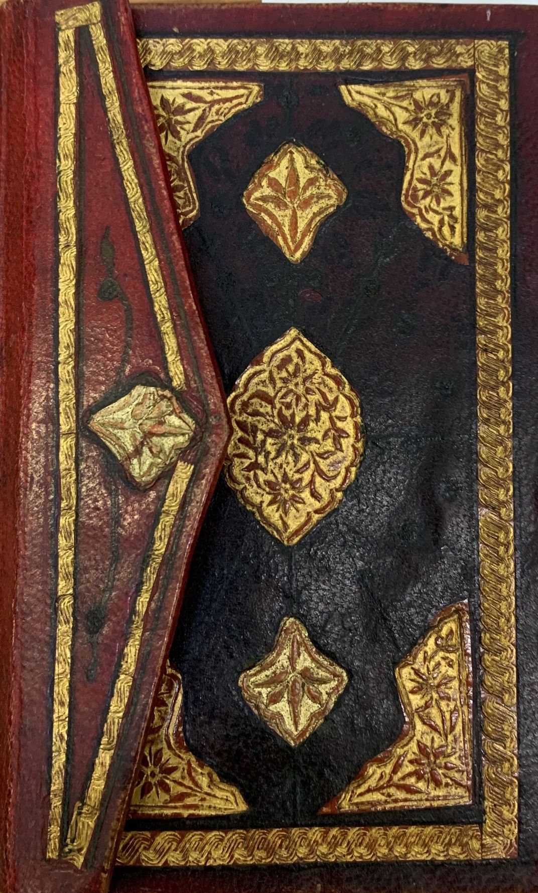 Ornate Qur ʾan with decorative leather binding.