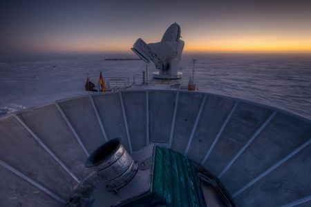 The sun sets behind the BICEP2 telescope at the South Pole.