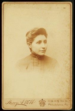 Black and white portrait of Susan La Flesche Picotte on a photo card from the shoulders up.