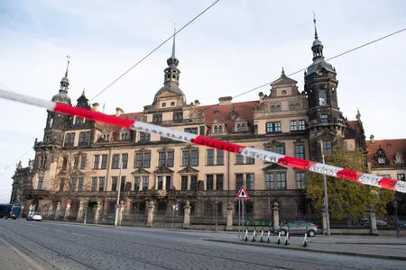A police barrier tape hangs in front of Dresden's Royal Palace, which houses the Green Vault.