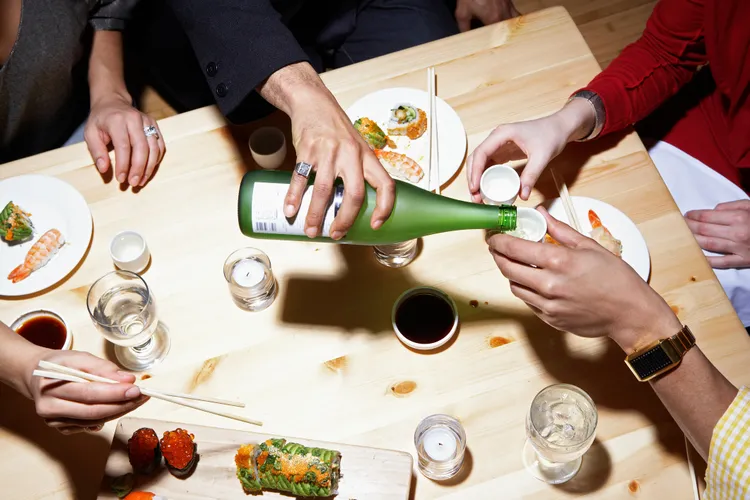 pouring sake at a table