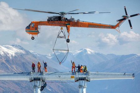 An Erickson Air-Crane above a powerline tower it helped erect in British Columbia. Each section of the tower weighed about 17,000 pounds.