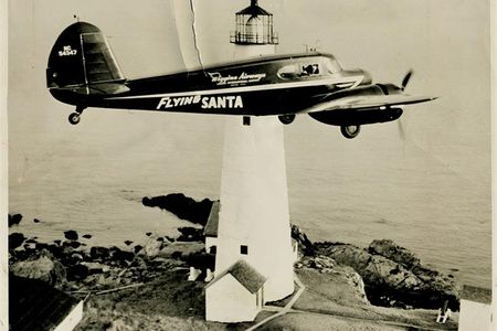 Flying Santa plane flies past Boston Light in 1947.