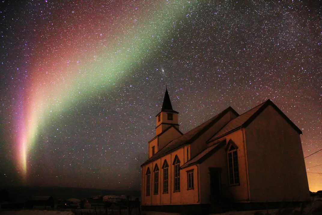 Northern Lights in the nigh sky above a church