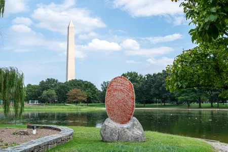Wendy Red Star&rsquo;s The Soil You See&hellip; is a seven-foot-tall glass red thumbprint featuring the names of chiefs who signed treaties with the American government, usually with a fingerprint.