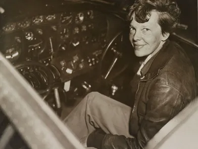 Amelia Earhart sitting in her cockpit