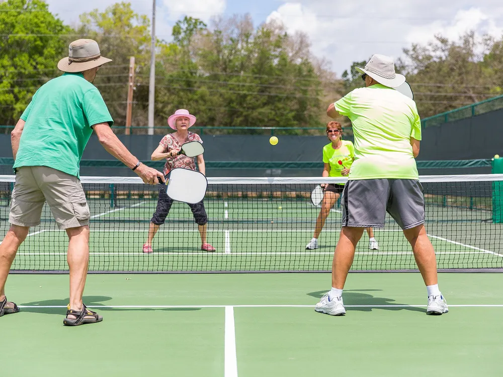 People playing pickleball on an outdoor court