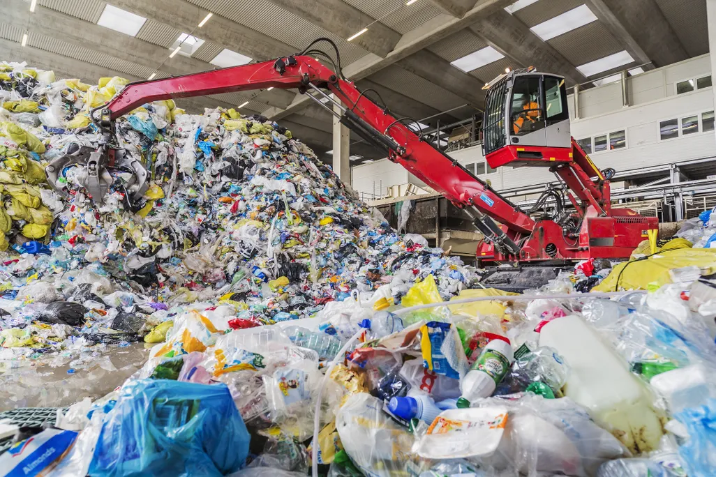 A mechanical grabber in a plastic recycling facility