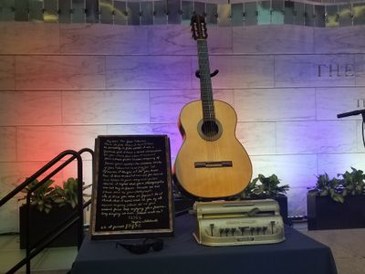 Clockwise from upper right, the items Feliciano donated to the Smithsonian included: his beloved Concerto Candelas guitar, a Braille writer his wife Susan used, a pair of his trademark glasses, and a heartfelt embroidered note from a Japanese admirer.