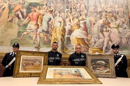 Italian officials pose with the three recovered artworks: Paul C&eacute;zanne&rsquo;s Still Life With Cherries,&nbsp;Pierre-Auguste Renoir&rsquo;s Les Poissons&nbsp;and Henri Matisse&rsquo;s Odalisque on the Terrace.