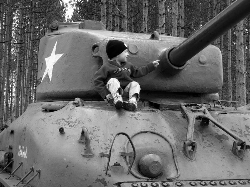 Boy sitting on Sherman tank Smithsonian Photo Contest Smithsonian
