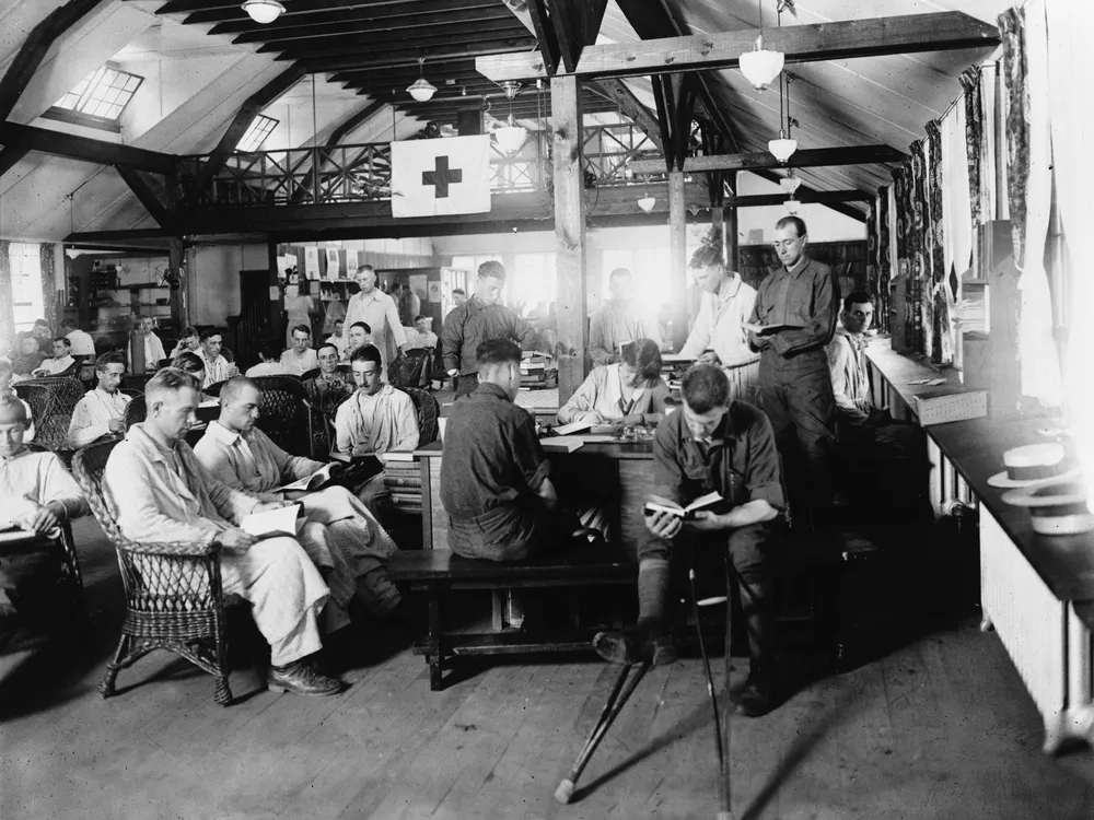 United States World War I soldiers reading in the War Library Service section of the Red Cross building at Walter Reed Hospital.