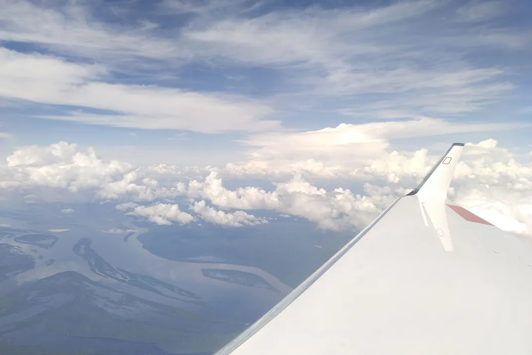 Plane Flying Over Forest and River
