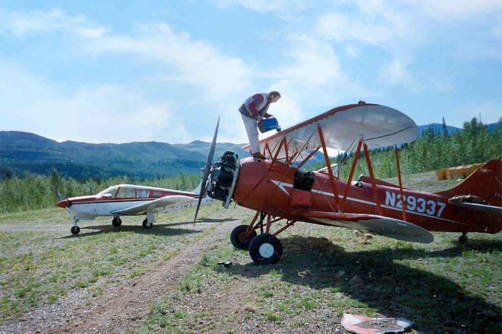 pilot refueling 1940 Waco on gravel strips