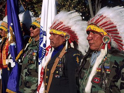 Native American veterans of the Vietnam War stand in honor as part of the color guard at the Vietnam Veterans War Memorial. November 11, 1990, Washington, D.C. 