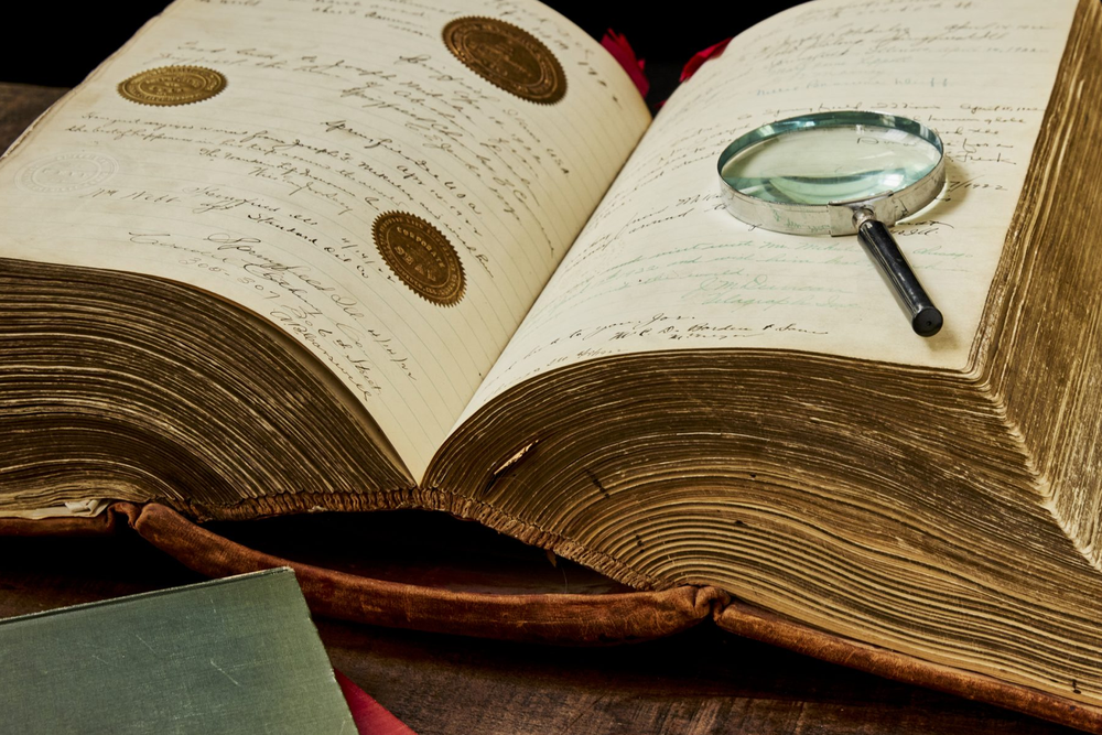 Joseph Mikulec's autograph book, with a magnifying glass on its open face