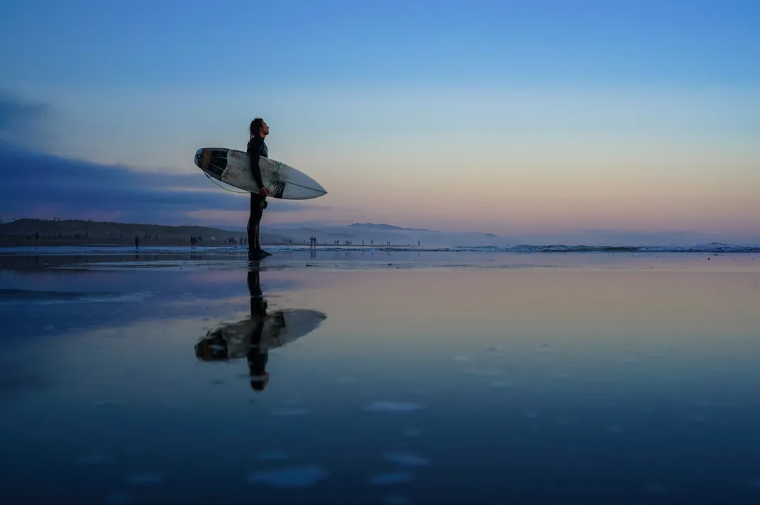 Surfer standing on the shore