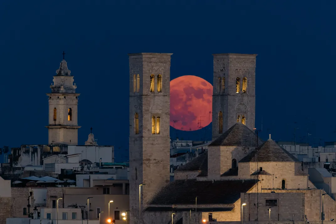 Strawberry moon is seen behind the towers of the Cathedral in Molfetta, Italy
