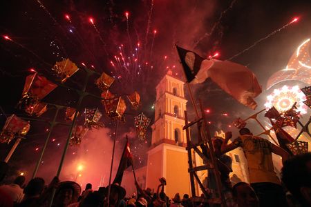 People launch fireworks during the traditional celebrations of Parrandas in Remedios, Cuba, December 25, 2013.