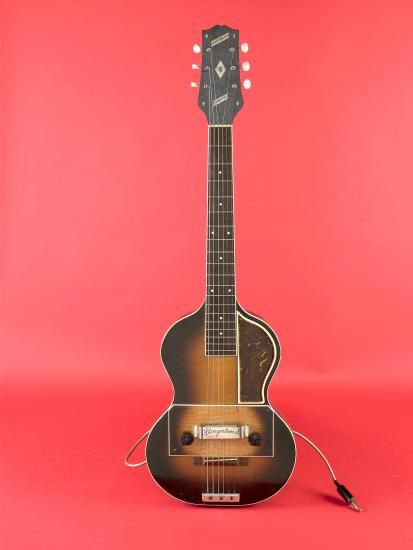 Brown guitar against red background