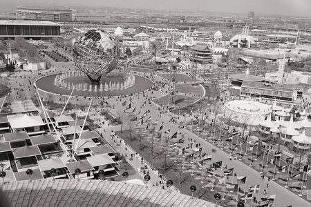 An overhead view of the 1964 World's Fair, showing the unisphere and surrounding pavilions.