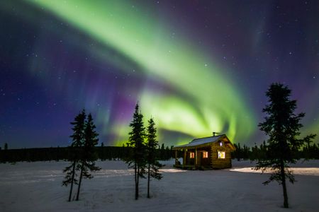 Northern lights over a wilderness cabin near Fairbanks, Alaska.