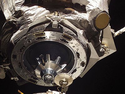 The Soyuz docking assembly's mating adapter is shown in space just feet away from the International Space Station.