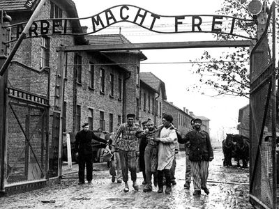 Soviet soldiers lead liberated prisoners out of Auschwitz in the winter of 1945.