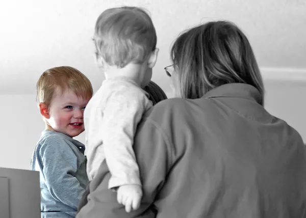 My young grandson is marveling at his reflection in the mirror. thumbnail