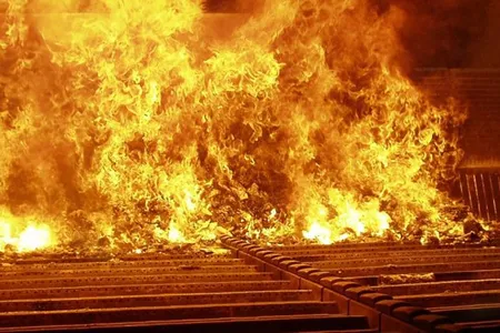 Municipal solid waste (aka garbage) being burned in an incinerator; this incinerator can handle 17 tons of trash an hour.