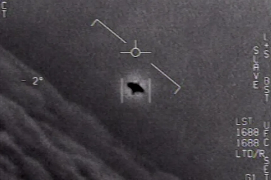 A black, unidentified object in the sky captured by a U.S. Navy jet.