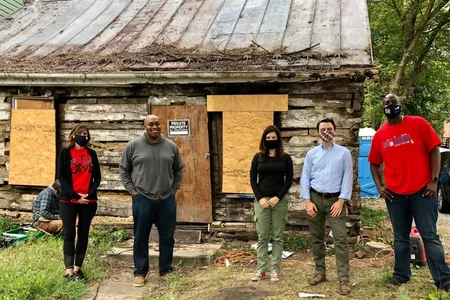 Archaeologists pose in front of the 180-year-old cabin in Hagerstown, Maryland.
