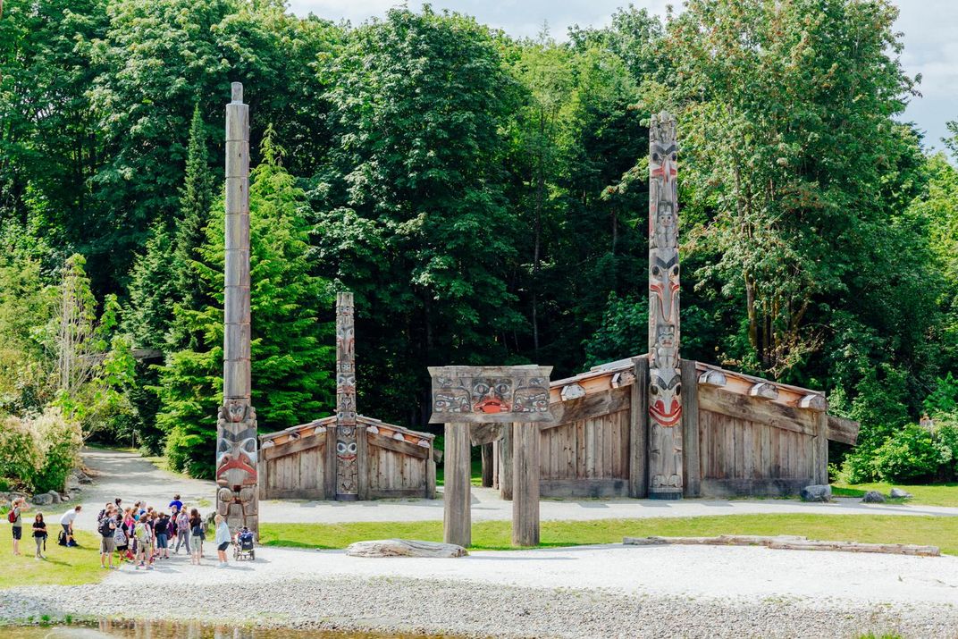 Totem poles and ceremonial house outside the Museum of Anthropology, Vancouver. Credit: Museum of Anthropology