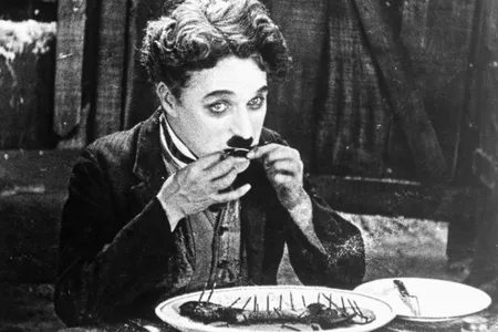 Charlie Chaplin eats his shoe in The Gold Rush (1925).