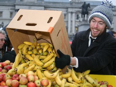 Activist Tristram Stuart adds to a collection of fruits during an event in Trafalgar Square designed to highlight food waste by feeding 5,000 people on rejected supermarket food.