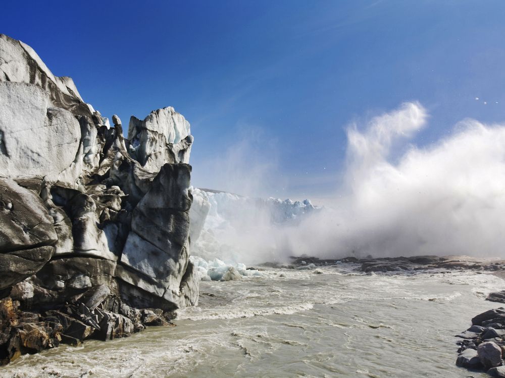 Ice collapsing off a glacier into a water flow below