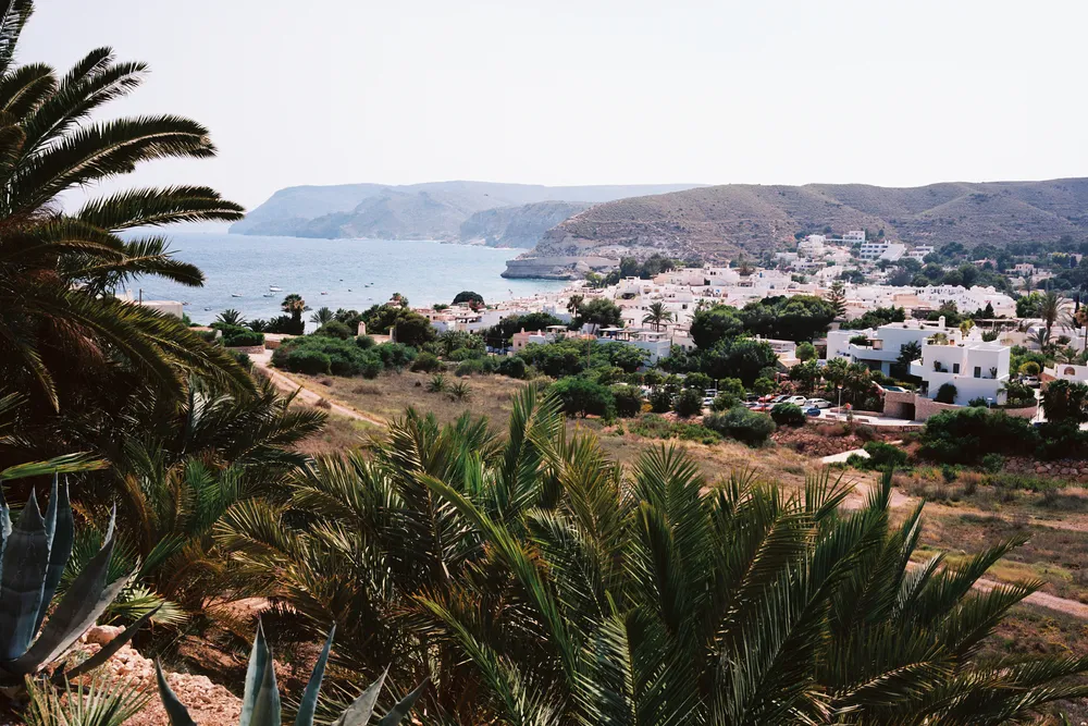 A coastal landscape with a village by the sea