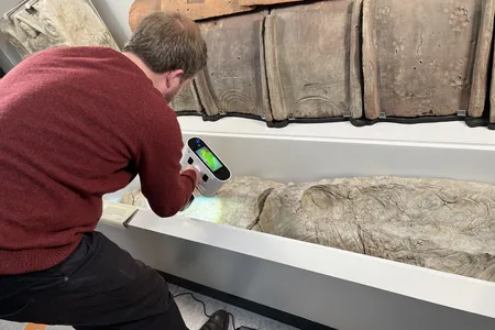 A researcher scans the negative cavity in the gypsum casing.