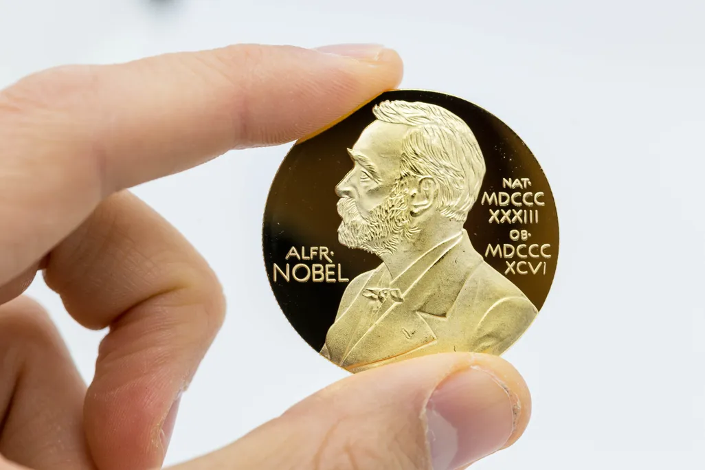 The gold medal that recipients are awarded, featuring the profile of alfred nobel.