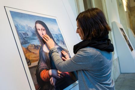A Prado visitor touches a 3-D printed replica of a contemporaneous copy of the "Mona Lisa."