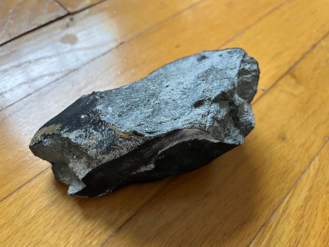 matte black rock on a hardwood floor
